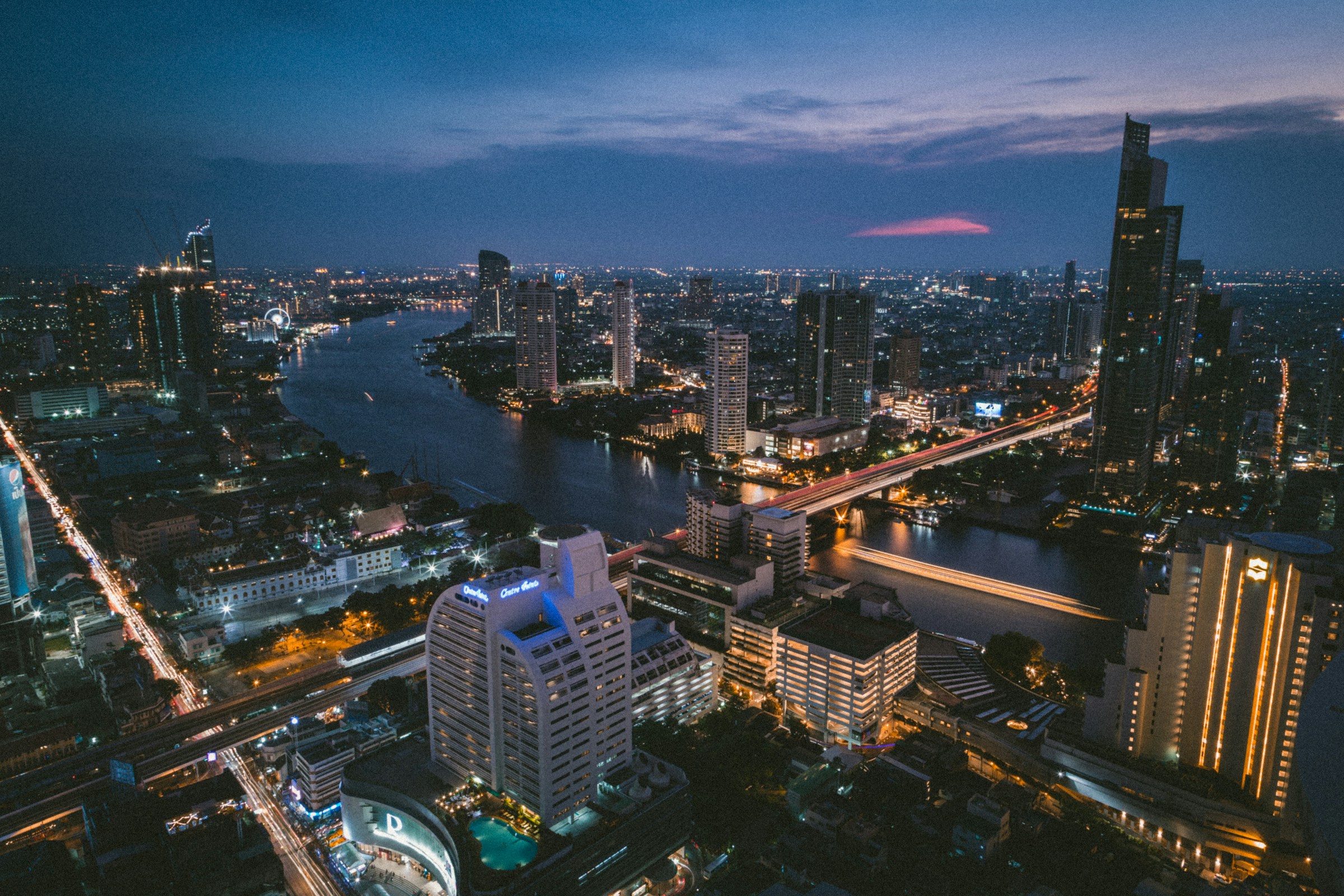Bangkok et ses gratte-ciel au bord du fleuve, à la tombée du jour